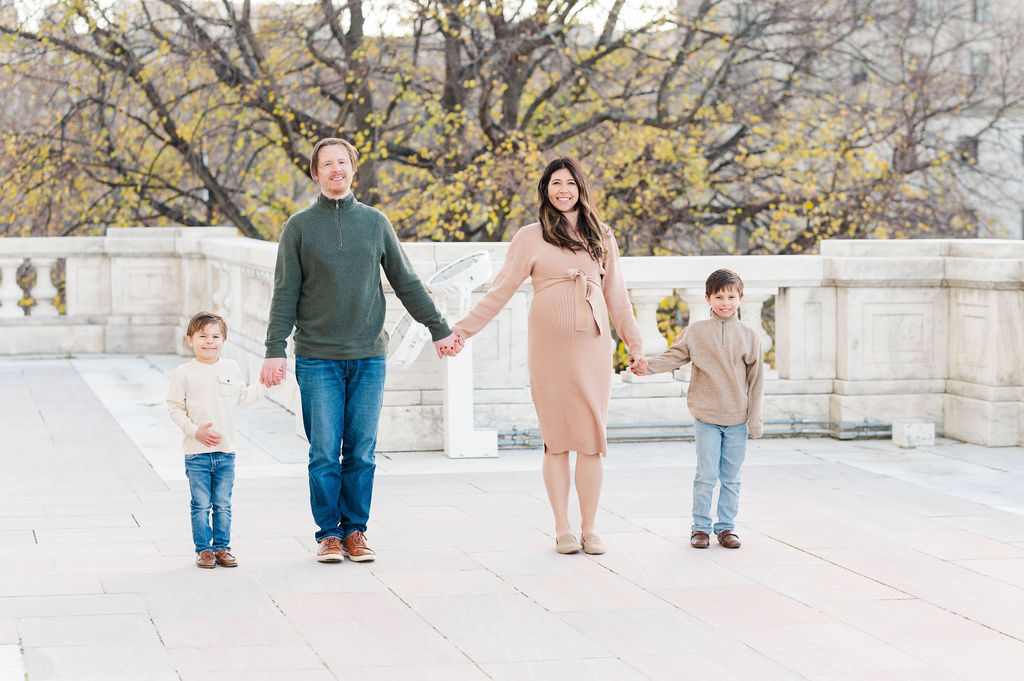 Family holding hands for maternity photos