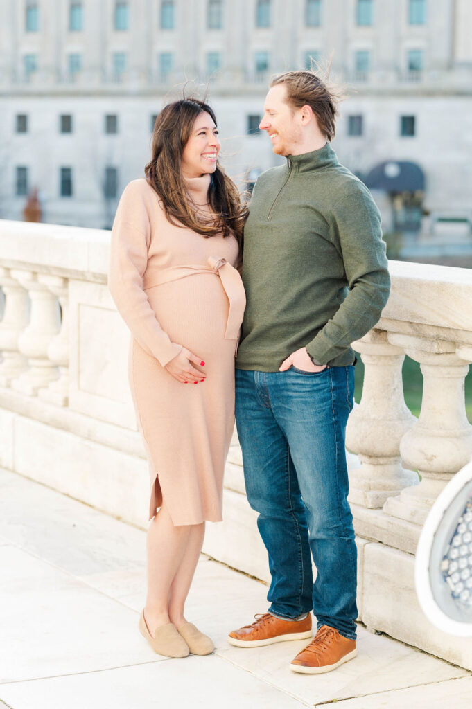 Husband and wife holding baby bump