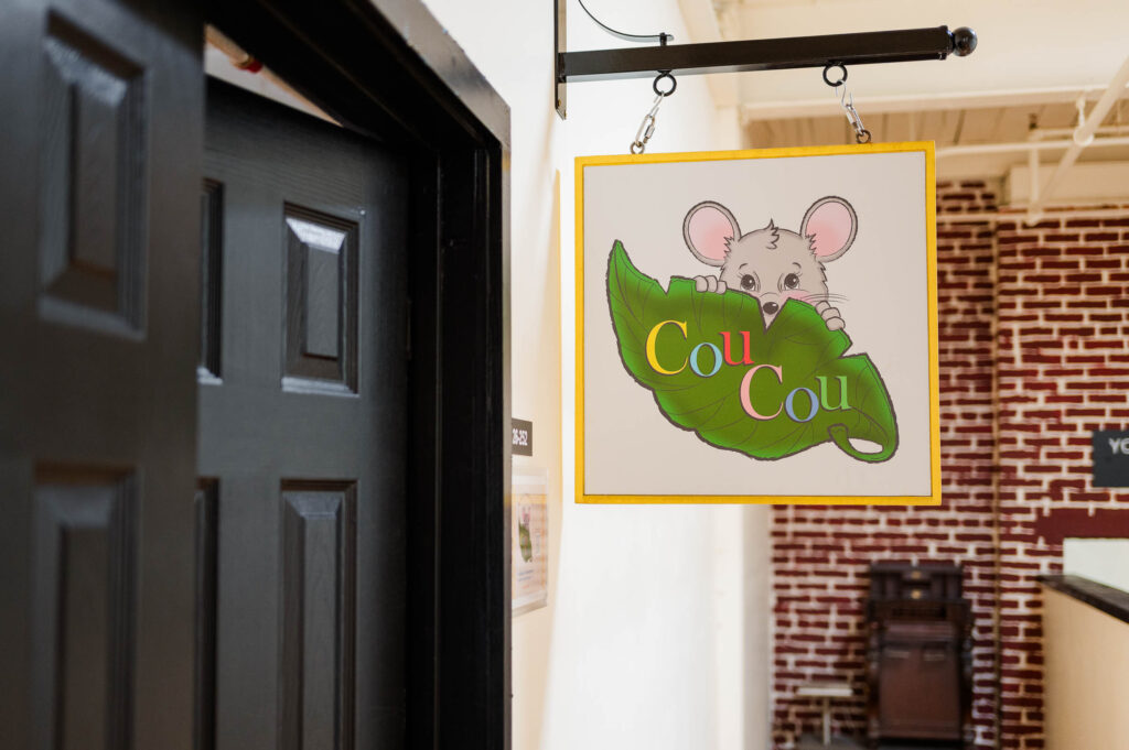 The CouCou shop sign it the hallway of the building in Norwood, MA