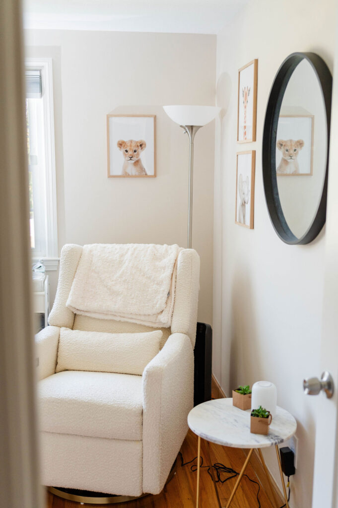 Baby boy nursery in Westwood, MA featuring the glider, mirror and prints