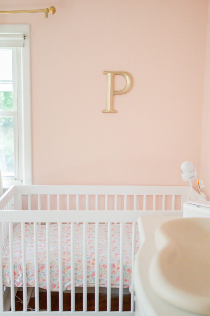Cute pink nursery wall with crib in Warwick, RI