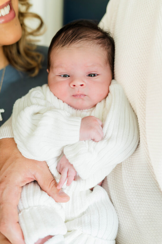 newborn baby with mom and dad behind taken by the best Franklin MA newborn photographer