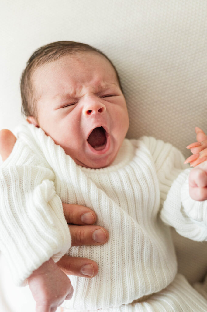 newborn baby boy yawning