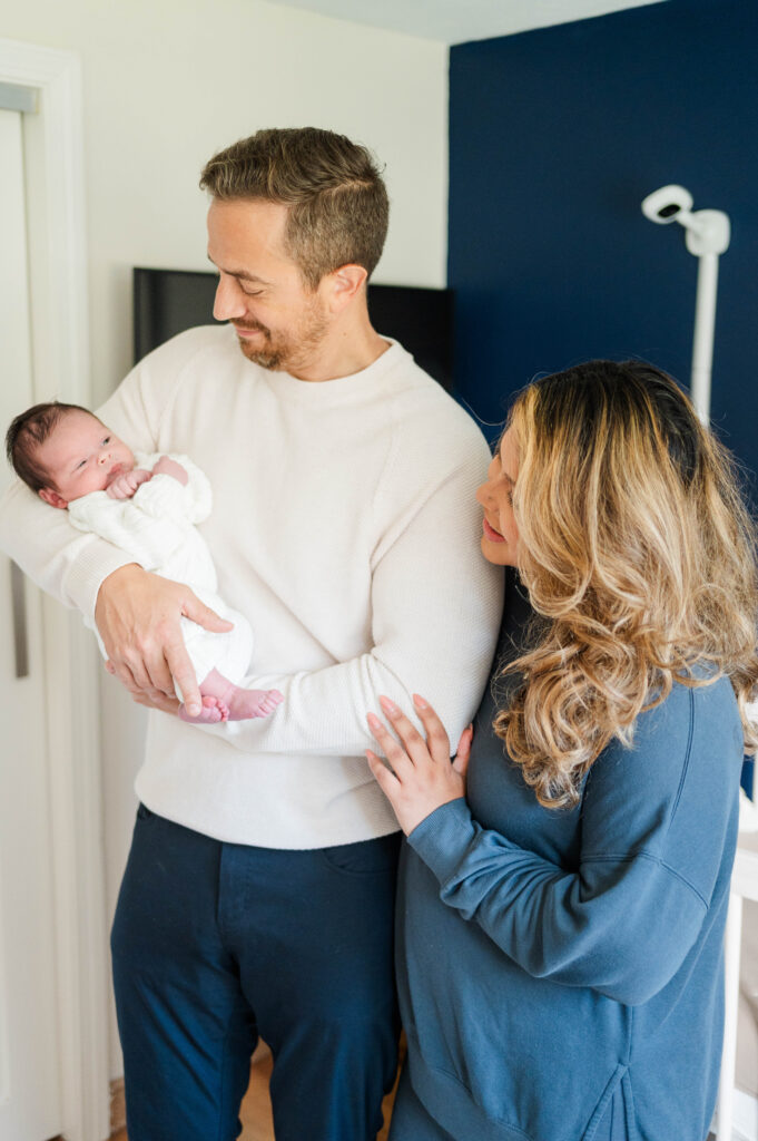 mom and dad looking at newborn baby