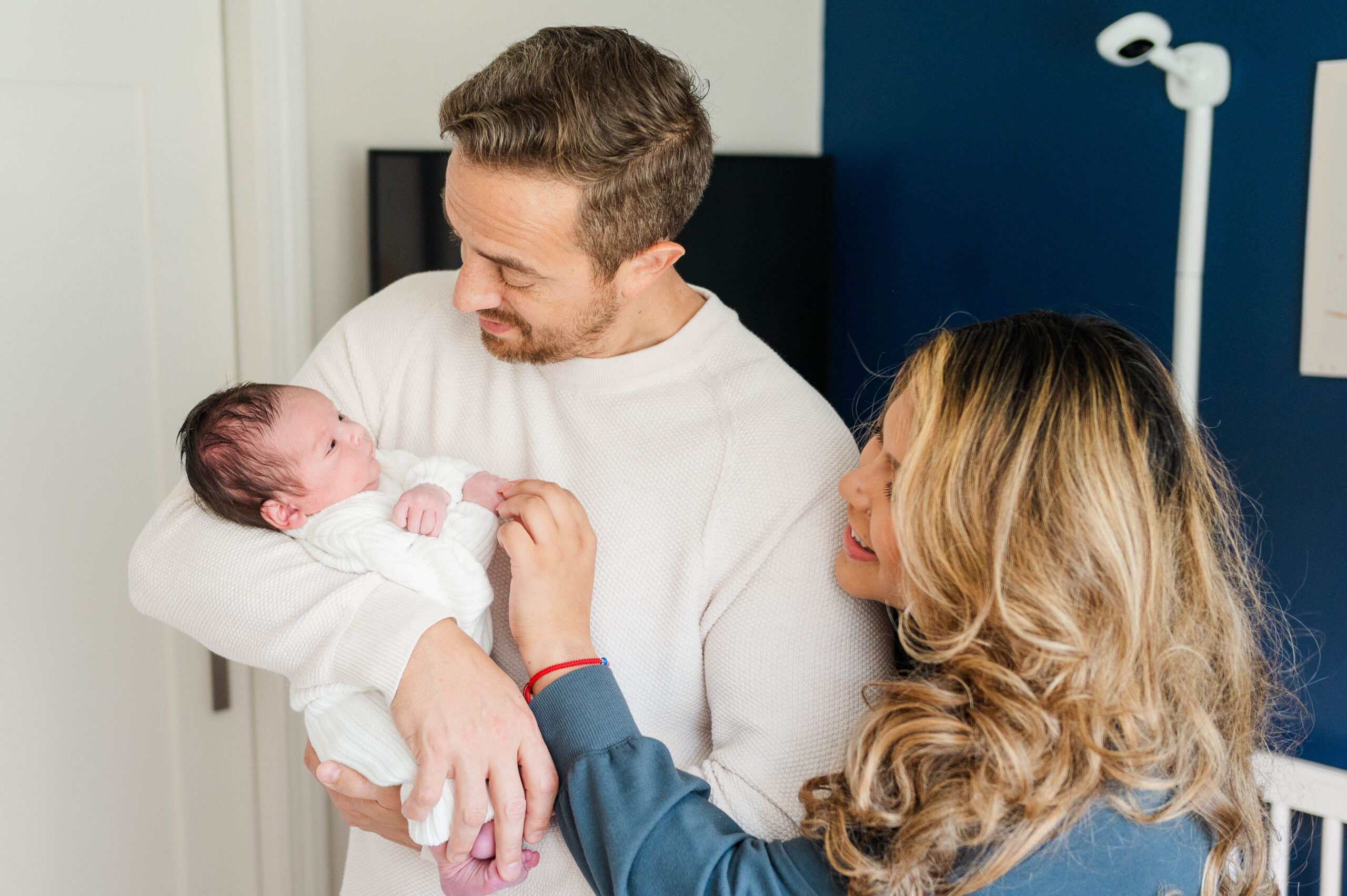 Mom and dad looking at newborn baby