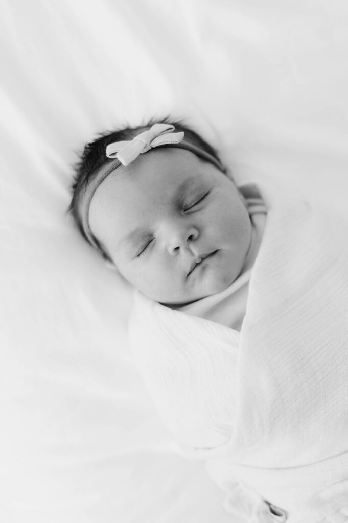 Newborn baby sleeping on bed in Walpole, MA 