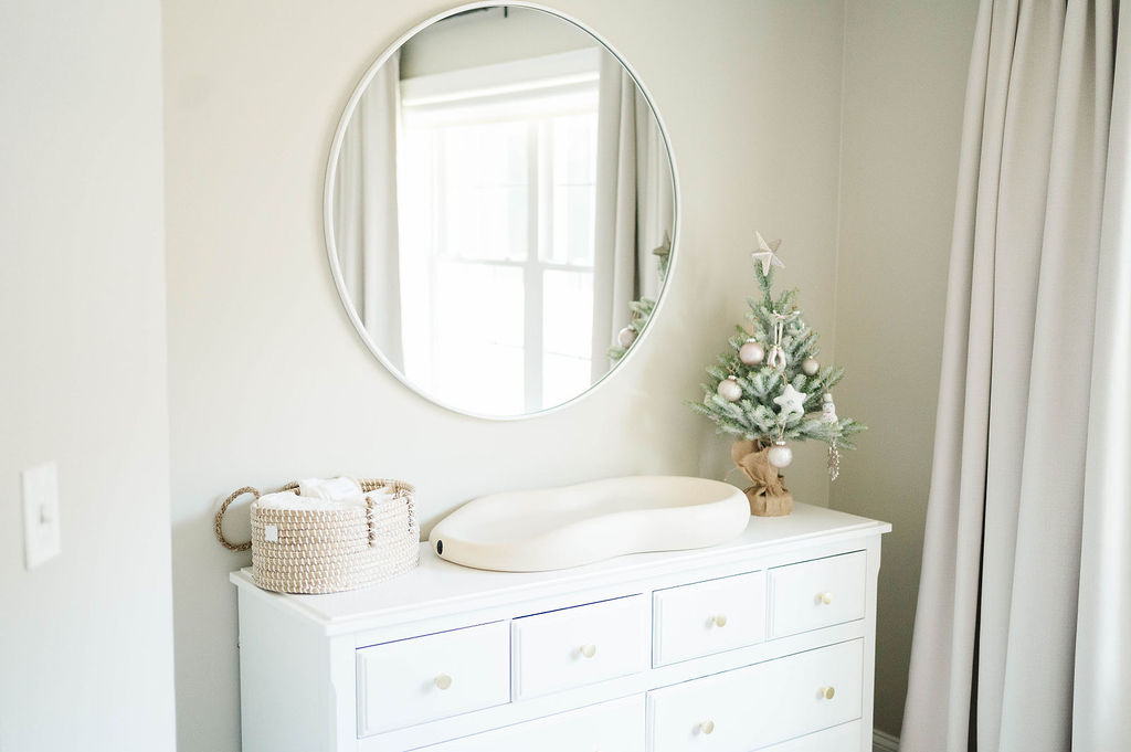 Nursery design with a mirror, dresser, and changing pad
