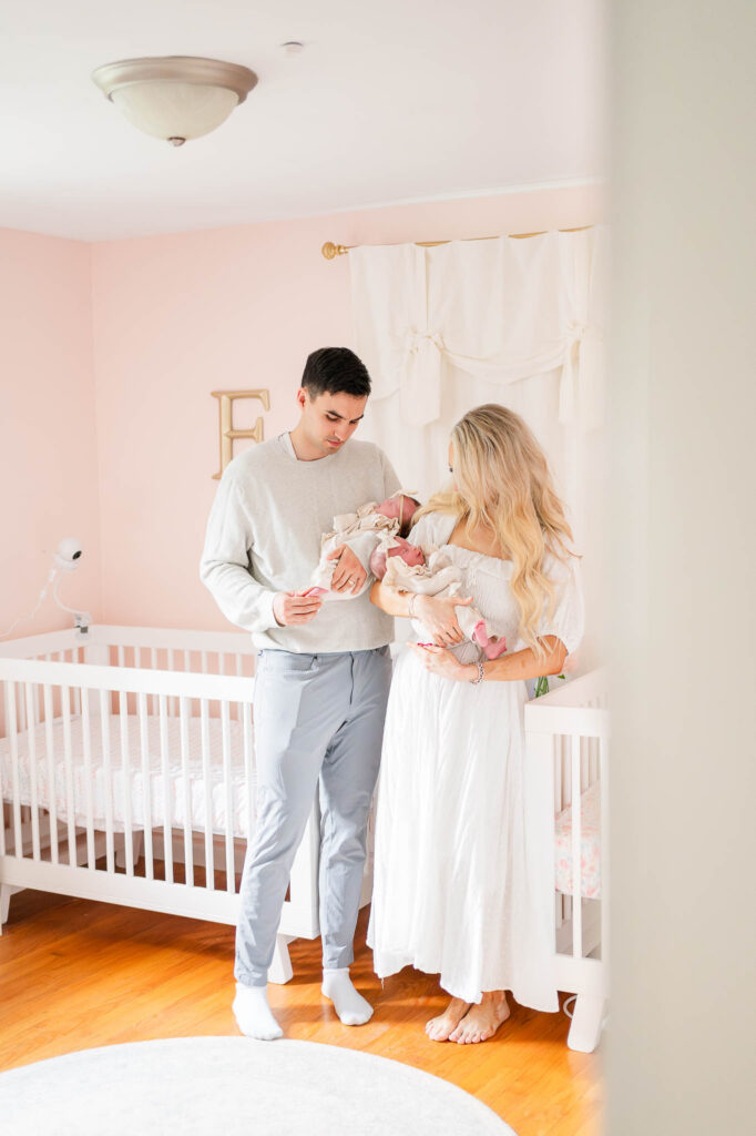 Rhode Island newborn photographer photo of mom and dad holding twin newborn girls