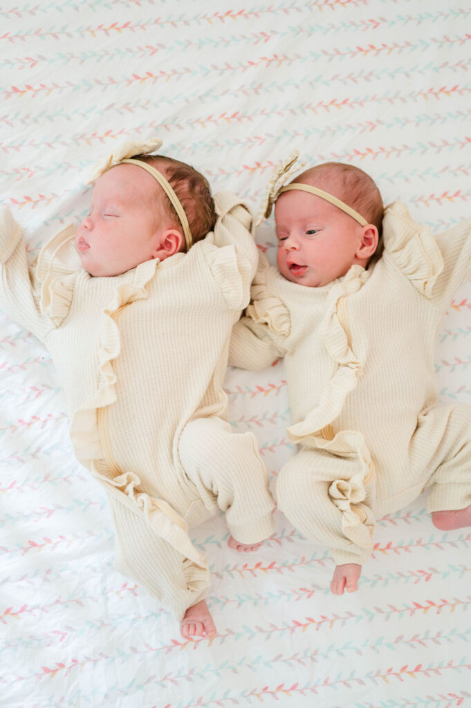 Newborn twins laying down next to each other