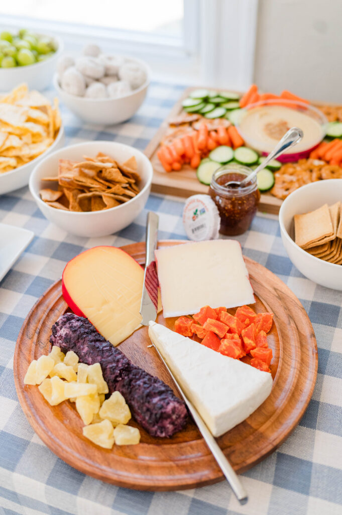 Fancy cheese plate on table with blue gingham tablecloth