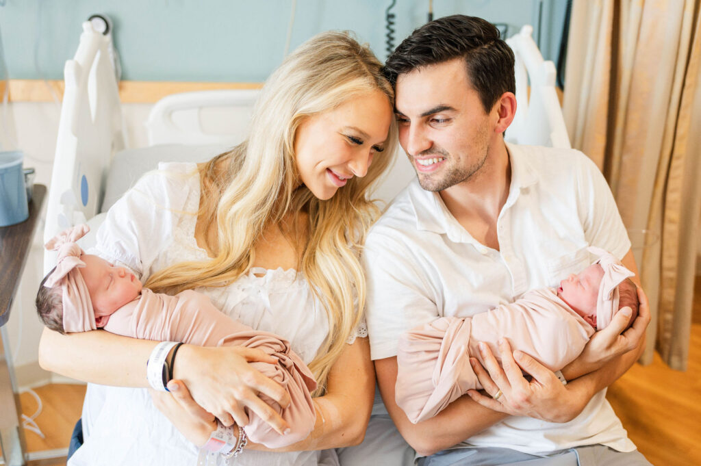 Best Boston Fresh 48 newborn photographer image of mom and dad and twins sitting on hospital bed