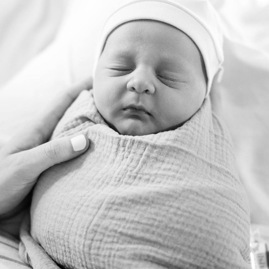 Boston Fresh 48 Photographer image of newborn wrapped in swaddle with hat