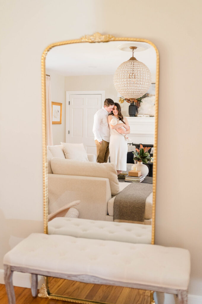 North Attleboro newborn photographer image of mom and dad gazing at baby in arms through a mirror