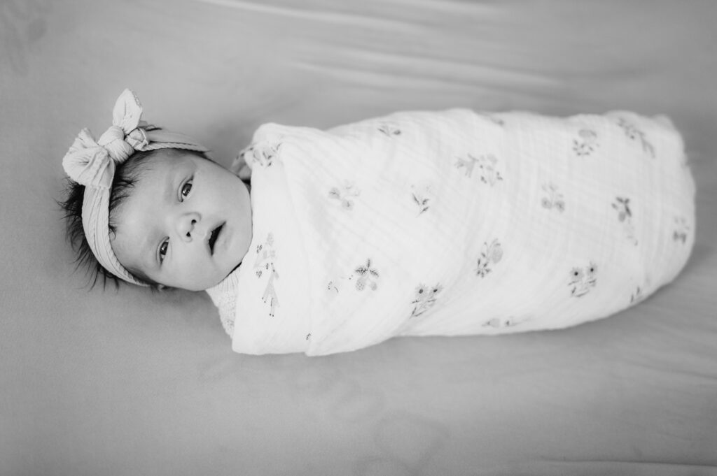 Mansfield newborn photographer image of newborn swaddled in crib
