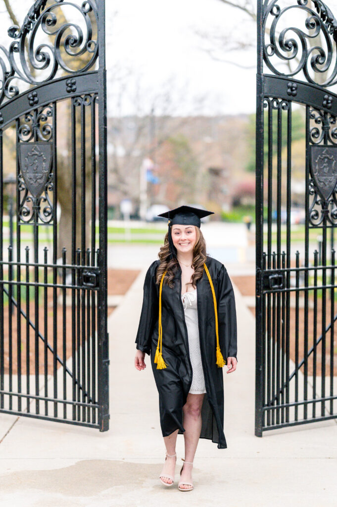 Worcester state university grad walking by gate