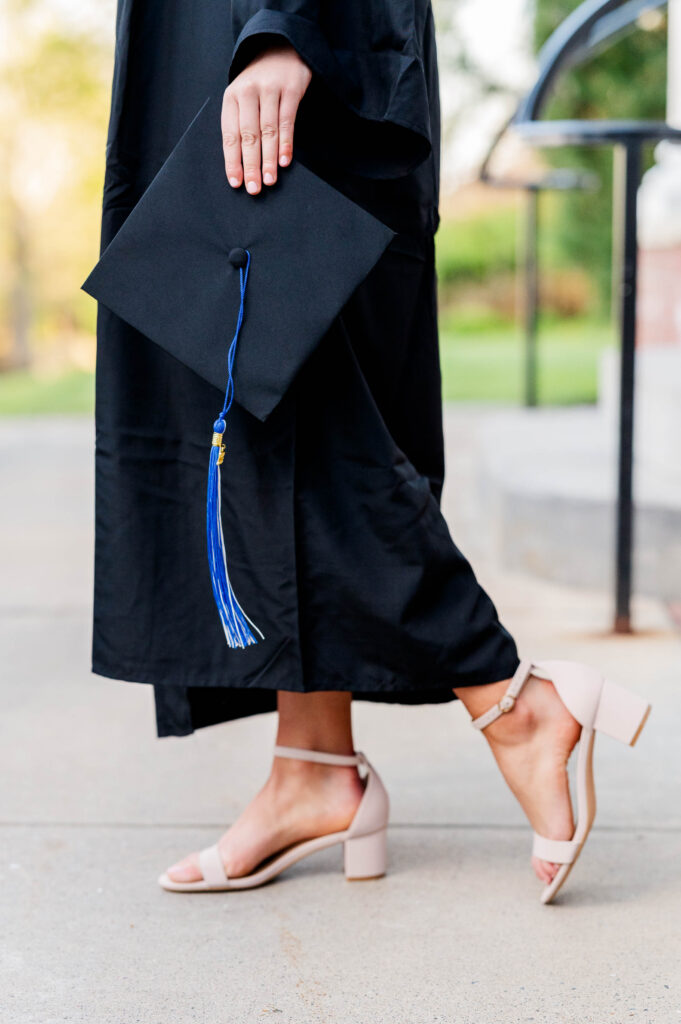 Cap and gown walking image from Assumption Unversity grad