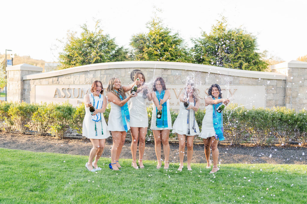 Assumption University grads celebrating with champagne