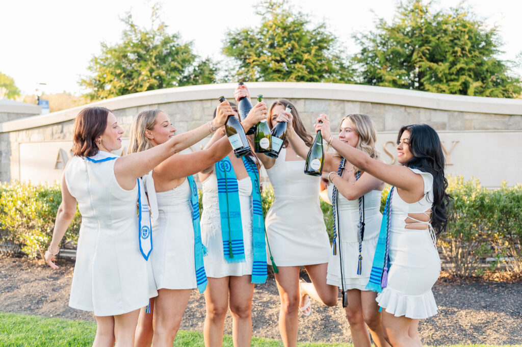 Group of girls cheersing with champagne bottles in Worcester, MA