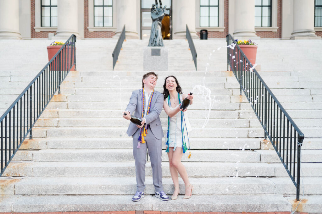Couple laughing during champagne spray at the College of the Holy Cross