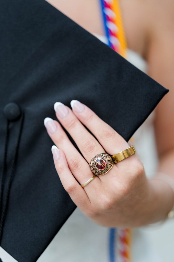 WPI grad holding cap and focus on the class ring