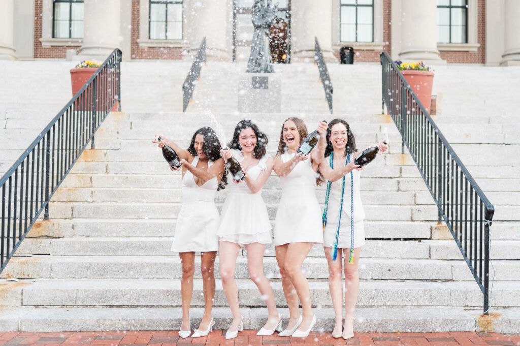 College of the Holy Cross group grad photography of champagne spray