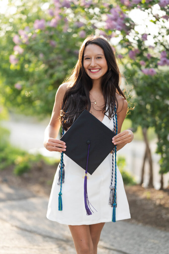 College of the Holy Cross grad with cap in hands
