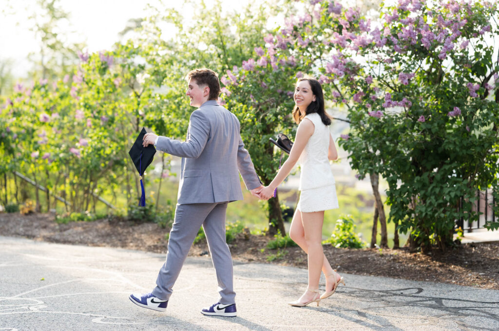 Couple walking during group grad session at the Collge of the Holy Cross in Worcester, MA