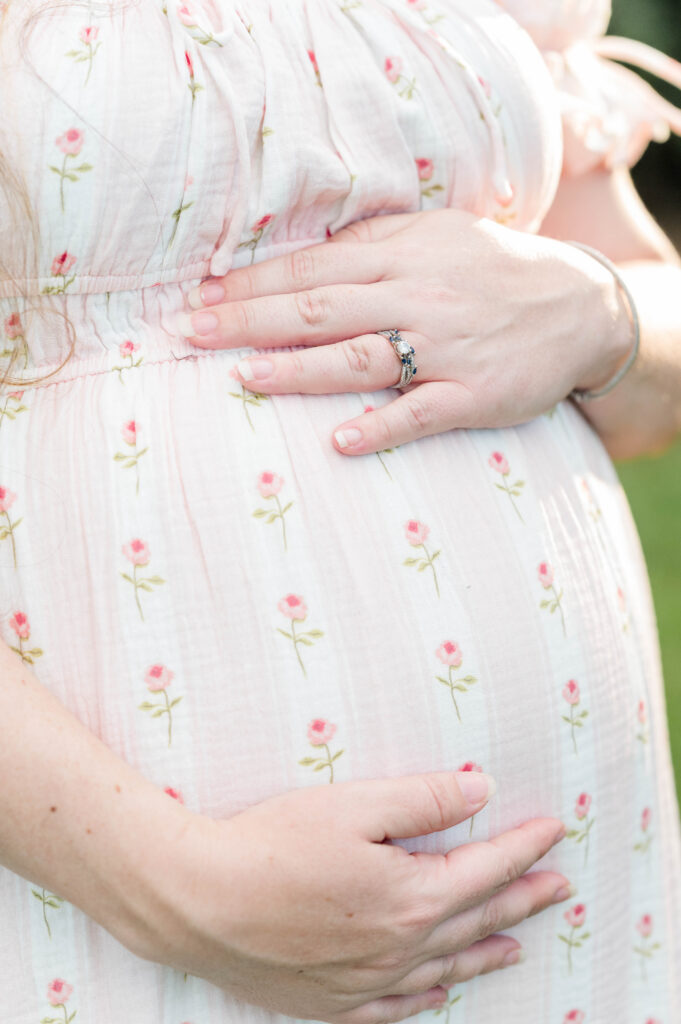 Mom holding her pregnant stomach for maternity shoot
