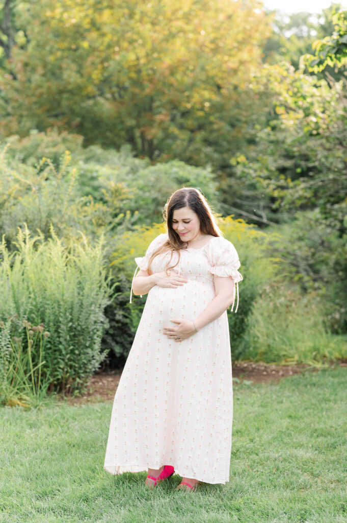 Sun shining behind expecting mom's hair in the arnold arboretum
